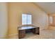 Bright living area with tiled floors and a built-in office space with a window at 3127 Kennewick Dr, Las Vegas, NV 89121