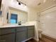 Updated bathroom features a large vanity, updated faucet and shower-tub combo at 3270 Liahona Way, Las Vegas, NV 89121