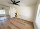 Bedroom features modern ceiling fan, mirrored closet doors, and vinyl wood flooring at 3270 Liahona Way, Las Vegas, NV 89121
