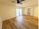 Bright bedroom featuring vinyl wood flooring, sliding glass door, and mirrored closet at 3270 Liahona Way, Las Vegas, NV 89121
