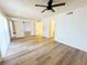 Bedroom features wood-look flooring, mirrored closet doors, and direct access to a bathroom at 3270 Liahona Way, Las Vegas, NV 89121