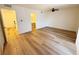 Bedroom with wood-look floors, a ceiling fan, access to a bathroom and well lit hall at 3270 Liahona Way, Las Vegas, NV 89121