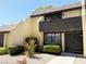 Townhouse front exterior with manicured landscaping, including shrubs and decorative rock at 3270 Liahona Way, Las Vegas, NV 89121