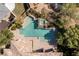 A bird's eye view showcases the unique pool design and mature landscaping at 33 Promontory Ridge Dr, Las Vegas, NV 89135