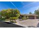 Paver driveway leads to charming stone-accented home with manicured landscaping at 33 Promontory Ridge Dr, Las Vegas, NV 89135