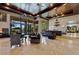 Expansive living room with travertine floors, a wet bar and views of the backyard at 33 Promontory Ridge Dr, Las Vegas, NV 89135