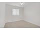 Clean and bright bedroom with large window and neutral carpet at 3621 Arcadian Sea St, Las Vegas, NV 89106