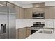 Close-up of the kitchen featuring stainless steel appliances and a stylish faucet at 3621 Arcadian Sea St, Las Vegas, NV 89106