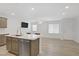 Open-concept living space featuring the kitchen with a stainless fridge and breakfast bar at 3621 Arcadian Sea St, Las Vegas, NV 89106