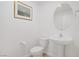 Bright powder room features a pedestal sink and a modern round mirror at 3621 Arcadian Sea St, Las Vegas, NV 89106