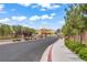 Street view of a planned community with blooming flowers and construction in progress at 3621 Arcadian Sea St, Las Vegas, NV 89106