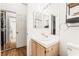 Bathroom featuring a vanity with tile countertop and wood-look floors, providing functionality and style at 3673 Ian Thomas St # 201, Las Vegas, NV 89129