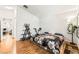 Spacious bedroom features wood flooring, exercise equipment and view into living area at 3673 Ian Thomas St # 201, Las Vegas, NV 89129