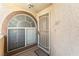 Close-up of a well-lit condo entrance featuring a decorative window and secure door at 3673 Ian Thomas St # 201, Las Vegas, NV 89129