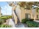 Condo exterior with nice landscaping, mature trees, and a private stairway entrance at 3673 Ian Thomas St # 201, Las Vegas, NV 89129