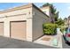 Exterior angle featuring a two-car garage, neutral color scheme, and well-maintained landscaping for curb appeal at 3673 Ian Thomas St # 201, Las Vegas, NV 89129