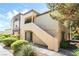 Charming condo exterior with well-maintained landscaping and a private entrance staircase at 3673 Ian Thomas St # 201, Las Vegas, NV 89129