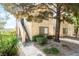 Inviting condo exterior with shade trees, lush landscaping, and a private entrance stairway at 3673 Ian Thomas St # 201, Las Vegas, NV 89129
