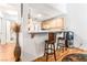 Open kitchen featuring bar seating with connection to the main living space at 3673 Ian Thomas St # 201, Las Vegas, NV 89129