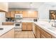 Functional kitchen with white appliances, ample counter space, and light wooden cabinets at 3673 Ian Thomas St # 201, Las Vegas, NV 89129