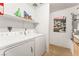 Convenient laundry room equipped with a washer, dryer, storage shelves, and water heater at 3673 Ian Thomas St # 201, Las Vegas, NV 89129