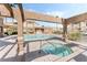 Community pool and spa area offering resort-style living with a spacious layout and covered lounging areas at 3673 Ian Thomas St # 201, Las Vegas, NV 89129