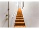 Wooden stairway leading upwards, featuring a white railing and a brightly lit entryway at 3673 Ian Thomas St # 201, Las Vegas, NV 89129