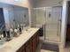 Bathroom vanity with double sinks, countertop space and a glass-enclosed shower at 3712 Garnet Heights Ave, North Las Vegas, NV 89081