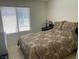 Comfortable bedroom featuring ample natural light and warm, inviting decor for relaxation at 3712 Garnet Heights Ave, North Las Vegas, NV 89081