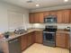 Well-lit kitchen equipped with stainless steel appliances and a practical layout, perfect for cooking at 3712 Garnet Heights Ave, North Las Vegas, NV 89081