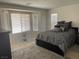 Serene main bedroom with large windows, neutral decor, and plush carpeting, a relaxing retreat at 3712 Garnet Heights Ave, North Las Vegas, NV 89081