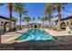 Beautiful community pool surrounded by palm trees, lounge chairs, and cabanas offers a resort-like experience at 3712 Garnet Heights Ave, North Las Vegas, NV 89081