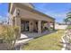 The backyard features a covered patio and a well-maintained garden with lush greenery at 4408 Oasis Plains Ave, North Las Vegas, NV 89085