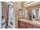 Well-lit bathroom featuring a vanity with dual sinks, a mirror, and a shower/tub combination at 4408 Oasis Plains Ave, North Las Vegas, NV 89085
