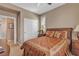 Inviting bedroom with a decorative bedspread, plantation shutters, and neutral paint at 4408 Oasis Plains Ave, North Las Vegas, NV 89085