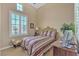 Cozy bedroom featuring a queen-size bed, window shutters and a ceiling fan at 4408 Oasis Plains Ave, North Las Vegas, NV 89085