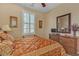 Cozy bedroom featuring a decorative bedspread, plantation shutters, and a dark wood dresser at 4408 Oasis Plains Ave, North Las Vegas, NV 89085