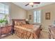Comfortable bedroom with a decorative bedspread, fan, and plantation shutters for a cozy atmosphere at 4408 Oasis Plains Ave, North Las Vegas, NV 89085