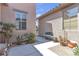 Charming courtyard area with a bench, table, and desert landscaping at 4408 Oasis Plains Ave, North Las Vegas, NV 89085