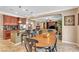 Open-concept dining room with tiled floors, wood table, and adjoining kitchen and living area at 4408 Oasis Plains Ave, North Las Vegas, NV 89085