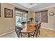 Bright dining room featuring wood table and access to the outdoor area through sliding glass doors at 4408 Oasis Plains Ave, North Las Vegas, NV 89085