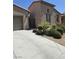 Attractive stucco home with desert landscaping, driveway, and decorative wrought iron gate at 4408 Oasis Plains Ave, North Las Vegas, NV 89085