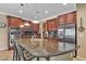 Well-equipped kitchen featuring granite countertops, stainless appliances, and a functional island at 4408 Oasis Plains Ave, North Las Vegas, NV 89085