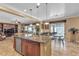 Open concept kitchen with granite countertops, stainless appliances, and an island with seating at 4408 Oasis Plains Ave, North Las Vegas, NV 89085