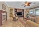 Comfortable living room with a fireplace, built-in shelving, and plush sofas for relaxation at 4408 Oasis Plains Ave, North Las Vegas, NV 89085