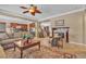 Beautiful living room showcasing a fireplace, plush seating, and seamless flow to the kitchen at 4408 Oasis Plains Ave, North Las Vegas, NV 89085