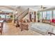 Open living room with tile flooring, a staircase, and lots of windows at 4408 Oasis Plains Ave, North Las Vegas, NV 89085