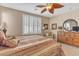 Comfortable main bedroom with plantation shutters, a ceiling fan, and traditional furniture at 4408 Oasis Plains Ave, North Las Vegas, NV 89085