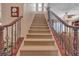 Carpeted staircase with wood and iron banister, and trim at 4408 Oasis Plains Ave, North Las Vegas, NV 89085