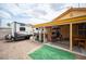 Backyard patio with a travel trailer, a barbecue grill and table under the overhang at 4616 E Idaho Ave, Las Vegas, NV 89104